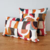 coussin motifs art déco aux couleurs chaudes orange et marron Les Ptits Coussins